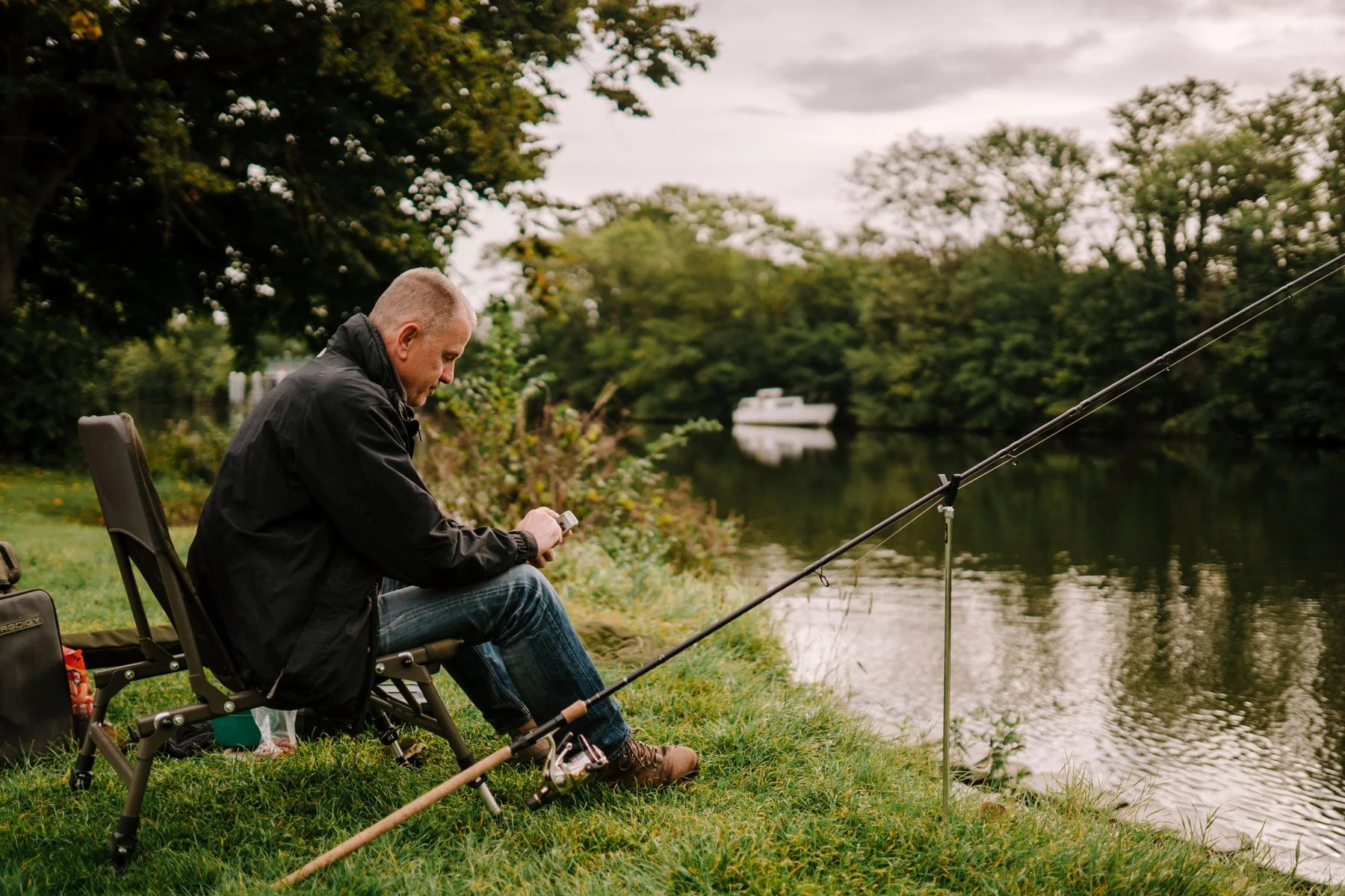 Angler sitting beside a river
